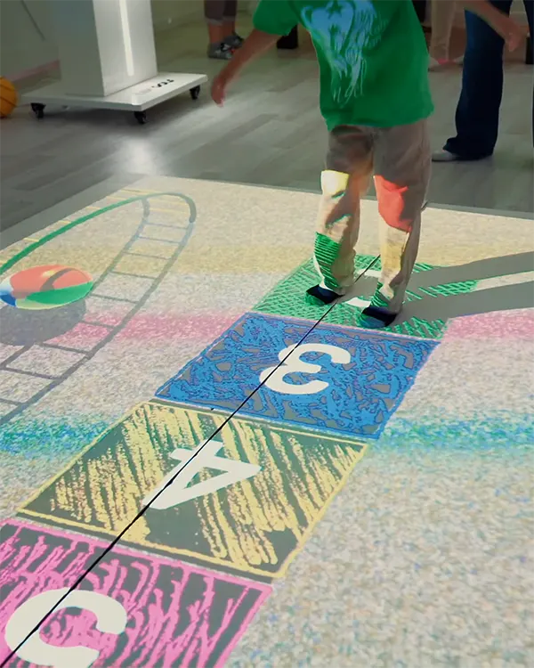 Child participating in an interactive floor game